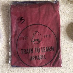 Train to learn apparel™️ next level T-shirt